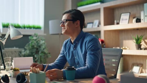 Man Working At Desk In Modern Office