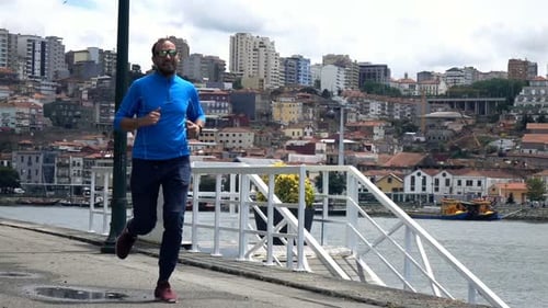 Young Man Jogging in City Near River, Super 240