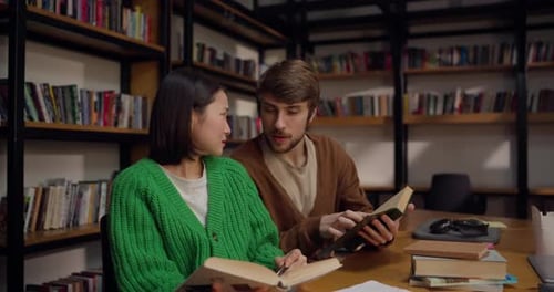 Man and Woman Reading in Library