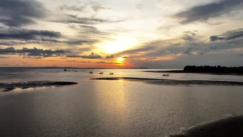 Aerial View of Sunset on Bali Beach with Fishing Boats