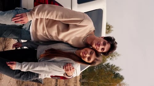 Happy Couple Hugging by Vehicle in Rural Setting