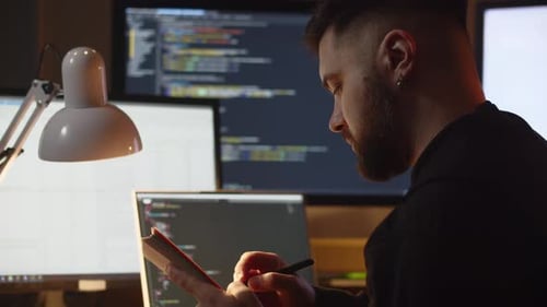 A Young Man is Learning Programming on His Own While Sitting at Home A Man Sits in Front of the