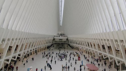 People walking inside the modern and spacious World Trade Center transportation hub in New York City