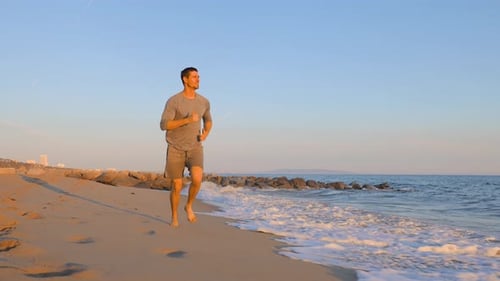 Athletic Man Exercising At The Beach