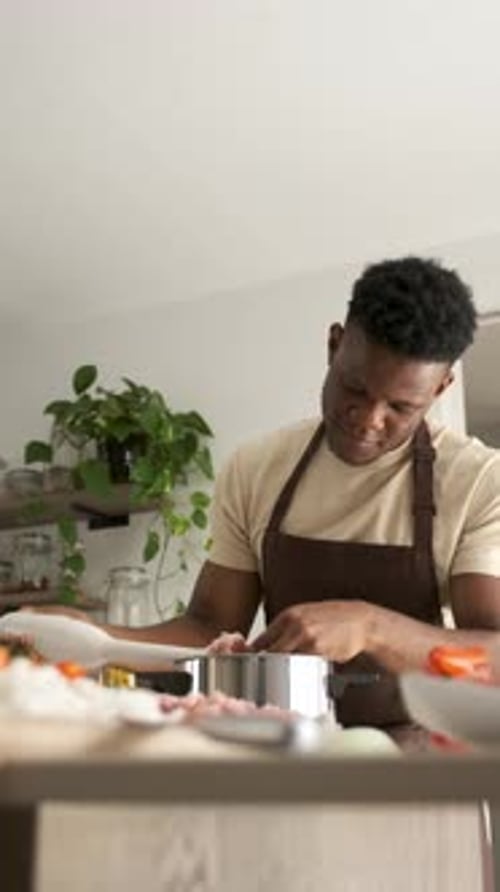 Young Adult Preparing Food in a Kitchen