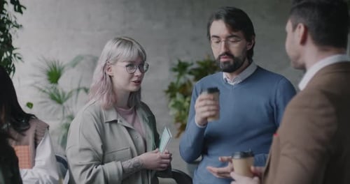 Conference Participants Talking and Drinking Coffee Discussing Lecture in Modern Business Hall