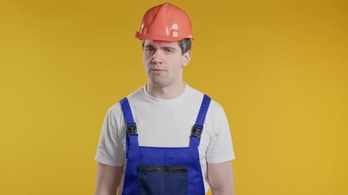 Serious Handyman Disapproving with No Head Sign Nods Head Denying Rejecting