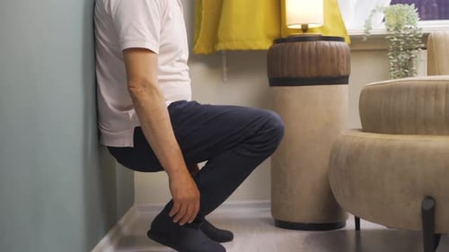 Adult Man Doing Wall Sit Exercise Indoors