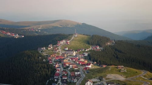 Panoramic video shooting view of the village located in lowland between the mountains.