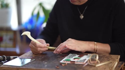 A woman making a stained glass work