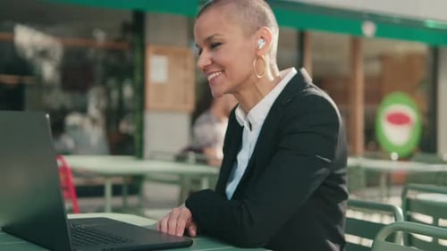Businesswoman in Video Conference at Outdoor Cafe