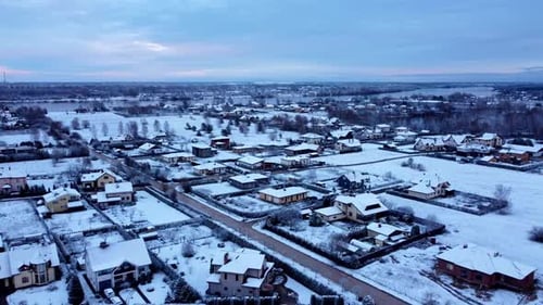 Aerial establishing shot of Katlakalns village, region in frozen Riga, Latvian landscape