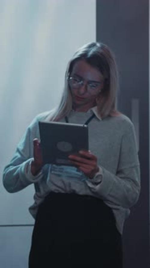 A Professional Woman Actively Using a Tablet in a Contemporary and Modern Office Setting