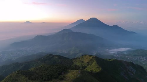 Breathtaking drone video of greenery mountain range with view of layered hills and mountain peak
