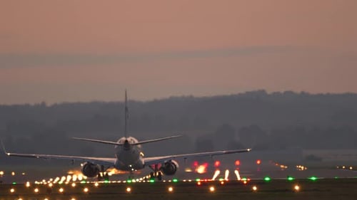 Cinematic footage of a jet plane taking off and climbing into the sunset.