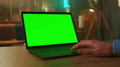 Close Up Man Hands of Freelancer Use Laptop with Green Screen At Home Working Scrolling Through