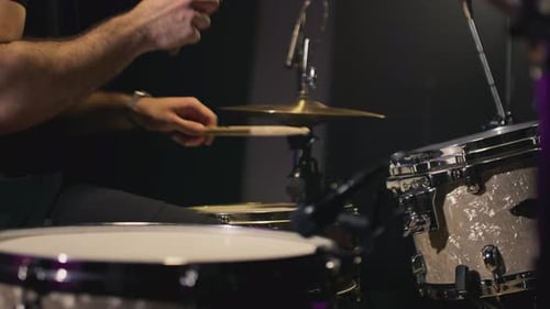 A Young Caucasian Man Drummer Plays a Drum Kit in a Music Studio Creates Music and Art Drum Set Drum