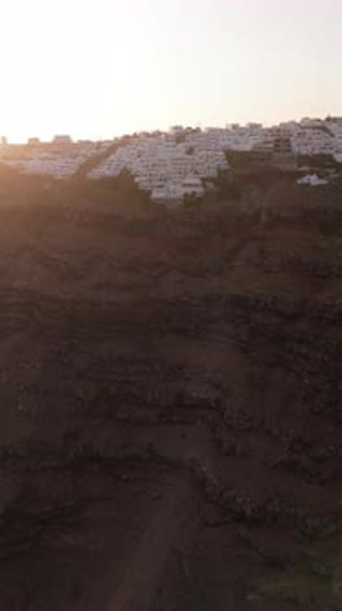 Experience the Stunning Aerial View of Santorinis Landscape During a Mesmerizing Sunset
