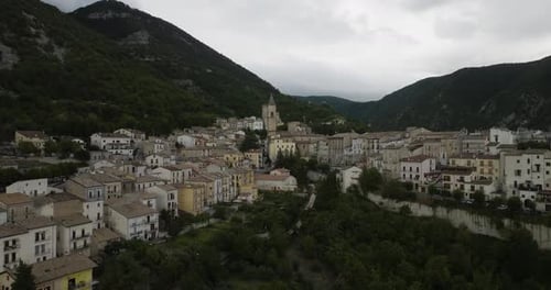 Aerial view of buildings near mountains, Italy.