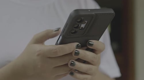 Close Up of Woman Hands Typing on Smartphone