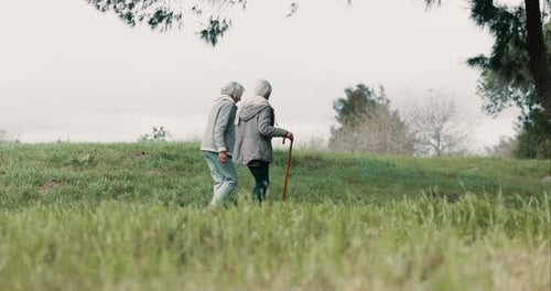 Park, friends and senior woman with walking stick to relax or quality time with hiking