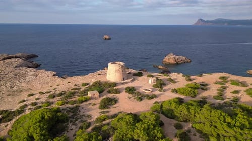 mediterranean coastal sunset ancient historic tower. Lovely aerial top view flight circle drone foot