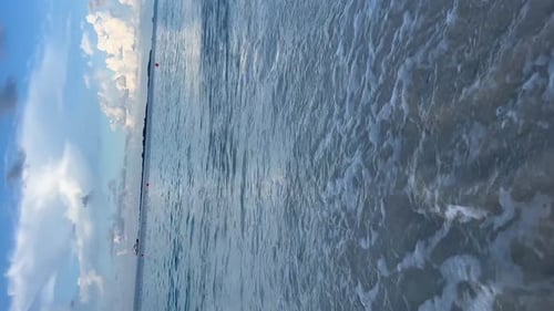 The waves of the sea erasing the prints of the feet marked in the sand