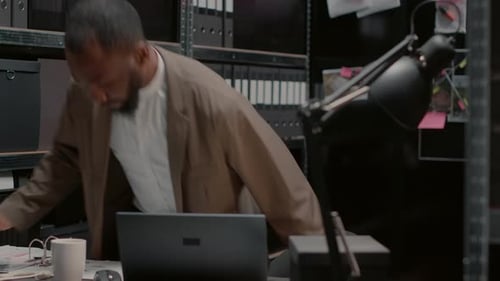 Man Working at Desk in Crowded Office