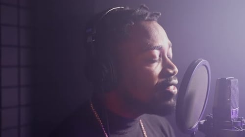 Handsome Black Man with Vocal Skills is Singing Loudly in Musical Recording Studio Portrait