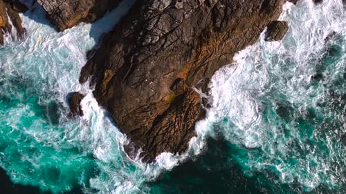 Bird's Eye View Of Rocky Coastline And Foamy White Waves In Summer. - aerial shot