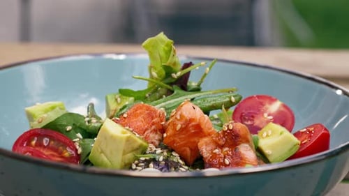 in a Restaurant on the Street on Plank Table a Blue Vertical Video Plate with a Warm Salad with