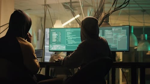 Hooded People Hacking Computers