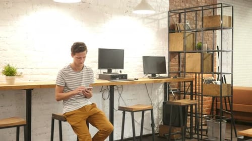 Casual Man Using Smartphone in Office