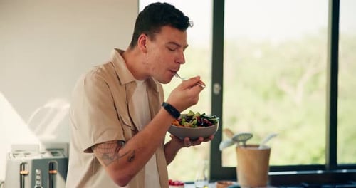 Young Man Enjoys a Healthy Salad at Home