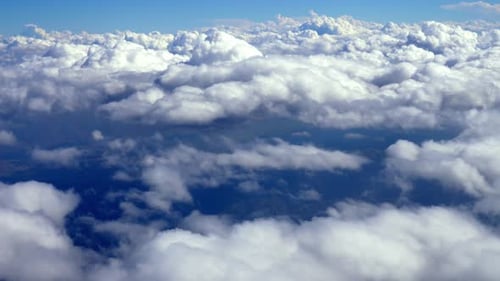 Aerial View of Fluffy White Clouds in Blue Sky