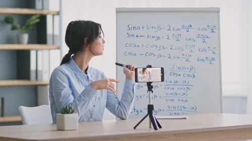 Young Woman Teaching Online Math Lesson With Smartphone