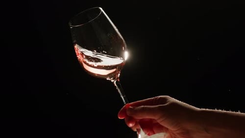 Orange or White Wine Bottle and Glass Against a Sunset in a Peaceful Vineyard Pouring of Ecological