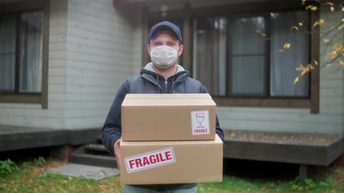 Portrait of Smiling Man Courier Delivery Standing With a Pizza Boxes and Coffee