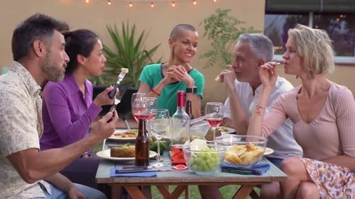 Friends Gather for Outdoor Meal and Conversation