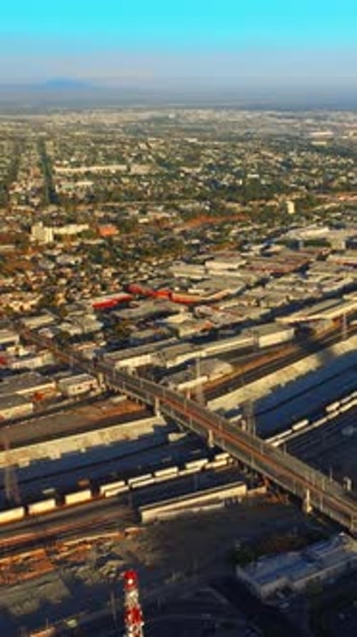 Cement canal for Los Angeles River crossed by bridges for transport.
