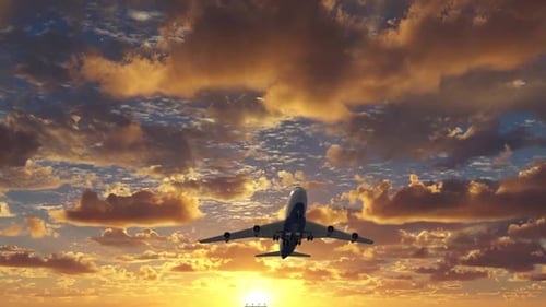 Passenger Airplane Take Off on a Background of the Scenic Yellow Sunset Sky