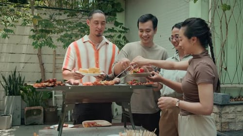 Friends Enjoying Backyard Barbecue on a Sunny Day