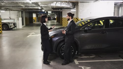 Caucasian Businesswoman Sells Car in Underground Parking Lot
