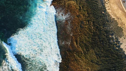 Empty Rocky Volcanic Beach Sea Ocean Waves Crashing and Foaming on Tropical Shore with Volcanic