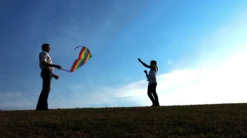 Father and Daughter Flying Kite on Open Field at Sunset, Steadicam