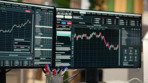 Close Up of Stock Exchange Metrics Candlestick Charts Displayed on Monitors