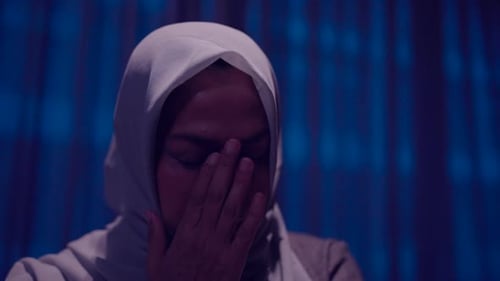 Woman in Headscarf Crying indoors