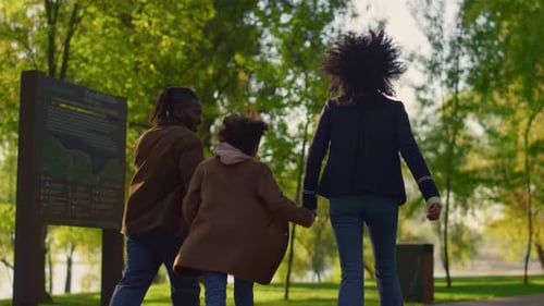 Happy Family Walk in Autumn Park