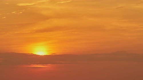 Golden Sunset Behind Clouds in Natural Setting