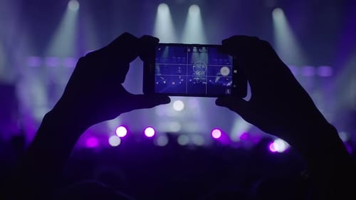 making photos with a smartphone on a live concert